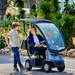 AFIKIM Blue Afiscooter C4 Mobility Scooter With Canopy And Rider On Terrain