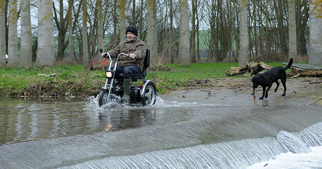 AFIKIM Silver Afiscooter SE Mobility Scooter With Rider Outdoor Crossing A Flooded Road