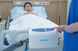 APEX Medical Wellell Domus Auto G2 Alternating Pressure Mattress System With Patient And Air Pump Mounted To Bed View