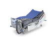 APEX Medical Wellell Optima Turn Lateral Rotation Pressure Relief Mattress In Bed Frame Half Covered With Air Cells And Air Pump View