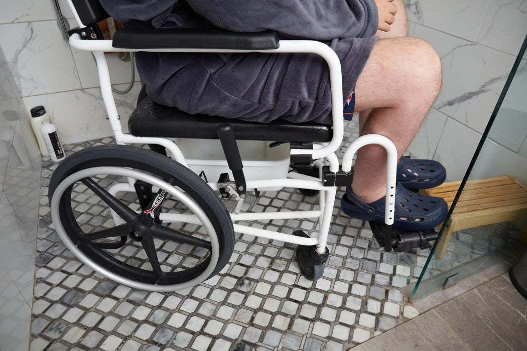 ActiveAid 600 Rehab Commode Chair Detailed Wheel View Highlighting Easy-To-Operate Foot Locks For Secure Positioning During Shower Transfers.