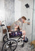 Altimate Medical ActiveAid 600 Mobile Rehab Commode Chair Side Perspective Showing A User In A Walk-In Shower For Safe And Accessible Personal Care.