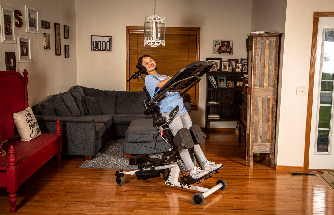 Altimate Medical EasyStand Bantam Medium White Supine Ready Stander With User In Slanted Standing Position Front Side View