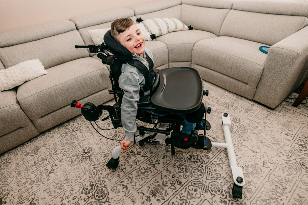 Altimate Medical EasyStand Bantam Small Stander With User Seated Top View Showing Tray And Positioning Straps