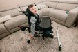 Altimate Medical EasyStand Bantam Small Stander With User Seated Top View Showing Tray And Positioning Straps