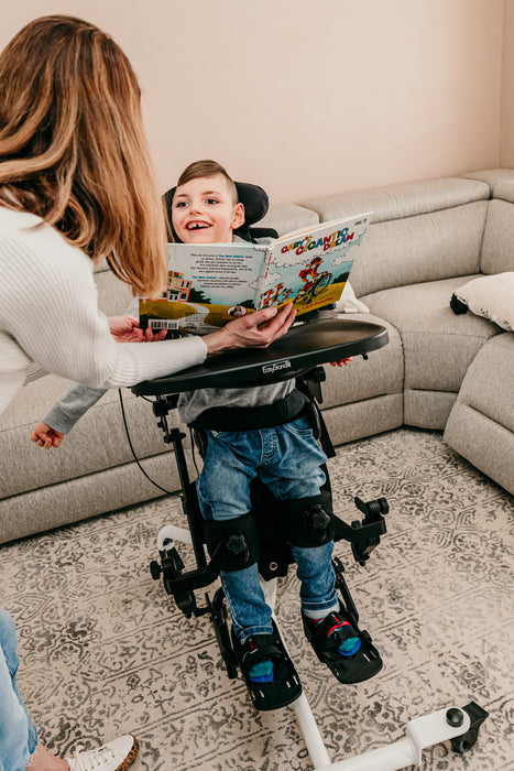 Altimate Medical EasyStand Bantam Small Stander With User Standing And Mother During Reading Activity