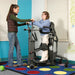 Altimate Medical EasyStand Glider Medium With Clear Shadow Tray In Upright Position Showing User And Carer Front Side View