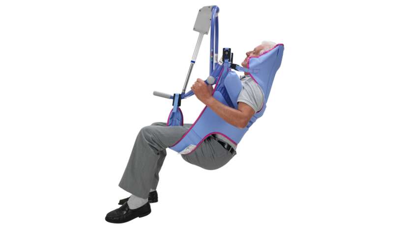Arjo Clip Toilet Sling with padded legs being used by a patient during toileting transfer.