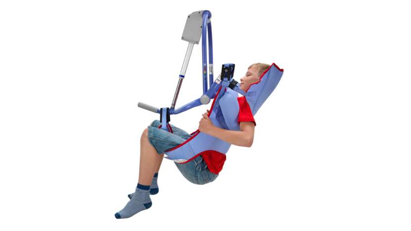 Arjo Clip Toilet Sling with padded legs being used by a pediatric patient during toileting transfer.