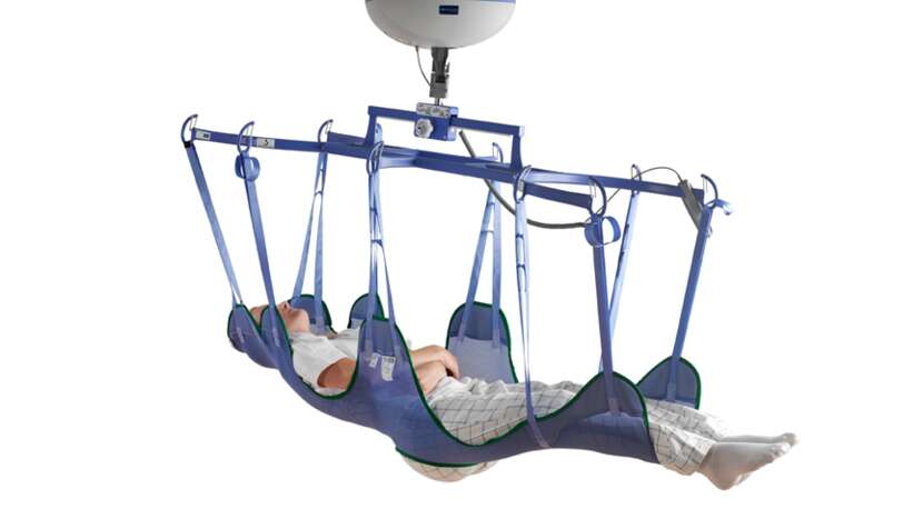Arjo Loop Bathing Stretcher Sling being used by a patient in a supine position during transfer.