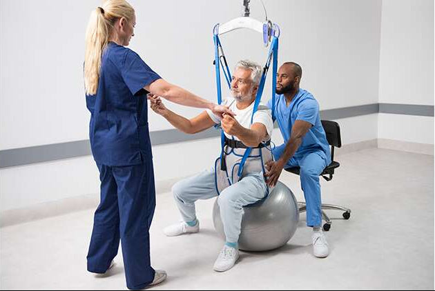 Arjo Loop Walking Sling In Use By Patient With Carer Assist For Mobility Training