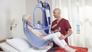 Arjo Maxi Move Patient Lift With Patient And Caregiver Bed Transfer Clip Sling View