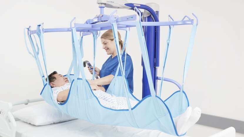 Arjo Maxi Move Patient Lift With Patient And Caregiver Bed Transfer View