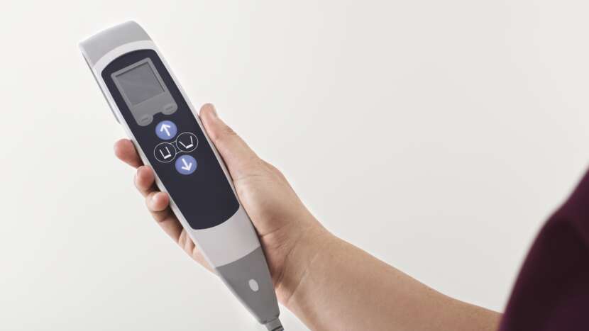 Arjo Sara Flex Sit To Stand Lift Hand Control View Showing Buttons For Safe Patient Transfer