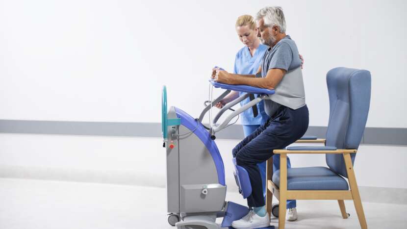 Arjo Sara Plus Wipeable Standing Sling Assisting Patient Chair Transfer With Caregiver