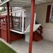Atlas Nano Vertical Platform Lift Installed Outdoors At A Mobile Home Carport Deck Enclosed With Clear Glass Panels
