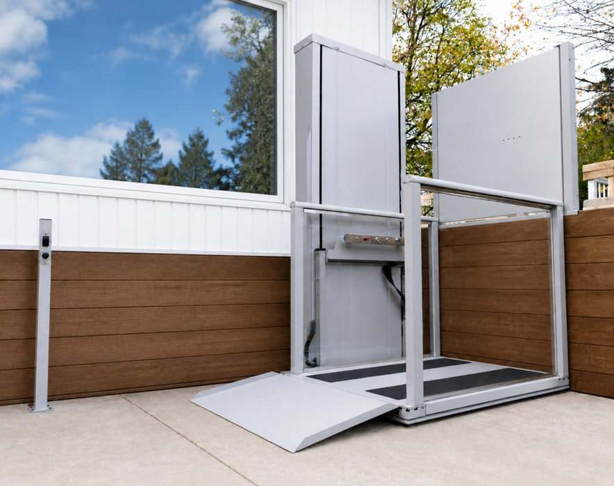 Atlas Nano Vertical Platform Lift Installed On An Outdoor Patio Enclosed With Clear Glass Panels And Equipped With An Access Ramp.