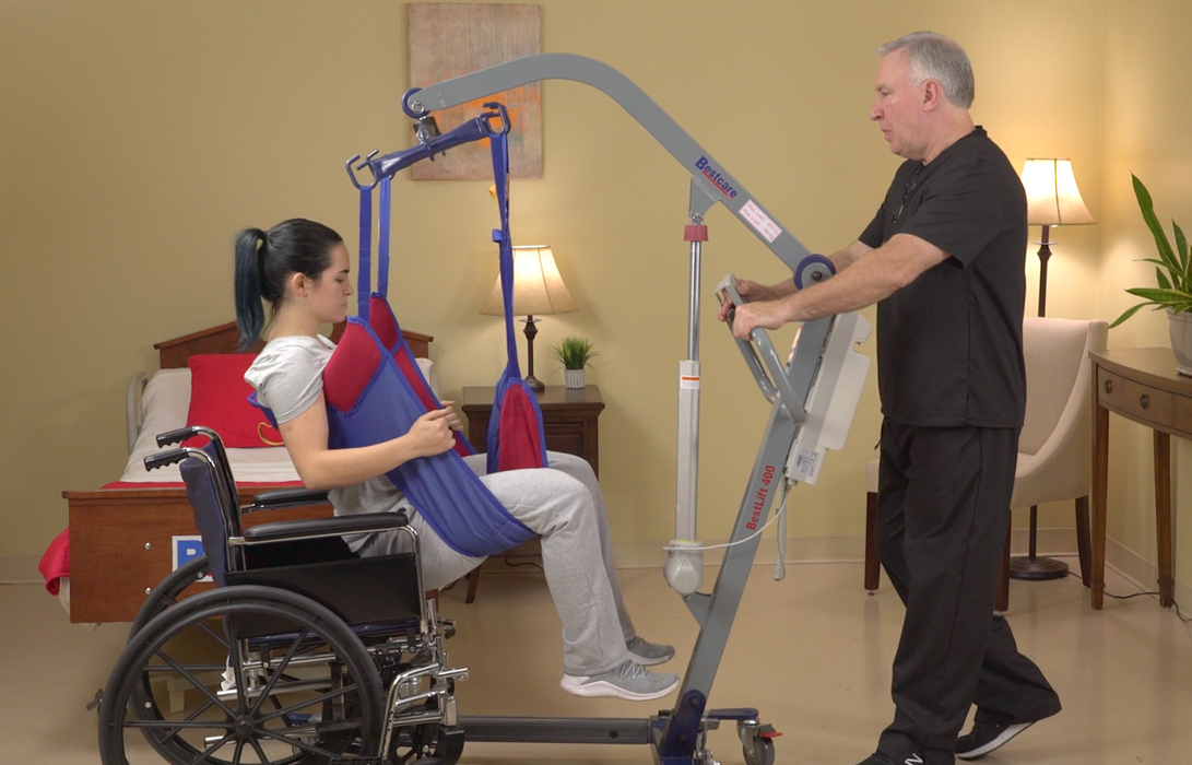 Bestcare BestLift ProCare PL400 Ergonomic Patient Lift With Caregiver And Patient Lifted From Wheelchair