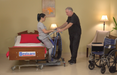 Bestcare BestMove STA450 Standing Transfer Aid With Caregiver And Patient Lifted In Bedroom Transfer