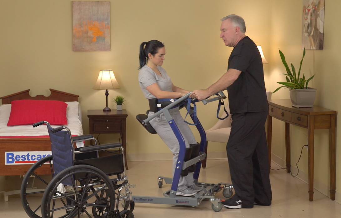 Bestcare BestMove STA450 Standing Transfer Aid With Caregiver And Patient In Wheelchair To Bed Transfer