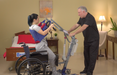 Bestcare BestStand ProCare SA400 Sit to Stand Lift With Caregiver And Patient Lifted In Wheelchair