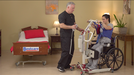 Bestcare BestStand SA400HE Mini Electric Sit-to-Stand Lift With Caregiver And Patient In Wheelchair Transfer