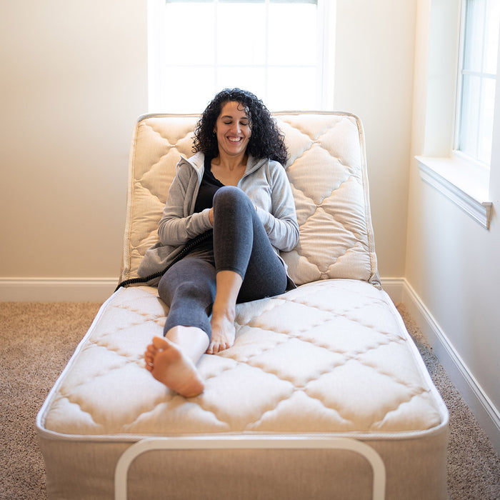 Flex-A-Bed Value Flex Base Frame In Raised Head Section With Patient Holding Wired Remote Control Front View