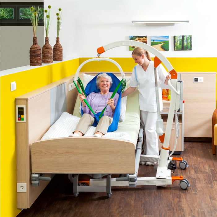 Handicare CARLO Alu Floor Lift With Anti-Rotation Mechanism For Safe Transfers And Fall Recovery Showing Bed Transfer
