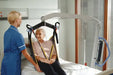 Joerns Hoyer Presence Patient Lift With Patient In Sling Attached Bed Transfer View