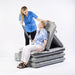 Joerns Mangar Camel Lifting Cushion With Patient Sitting In Assisted By Caregiver And Airflo 24 Decompressor View