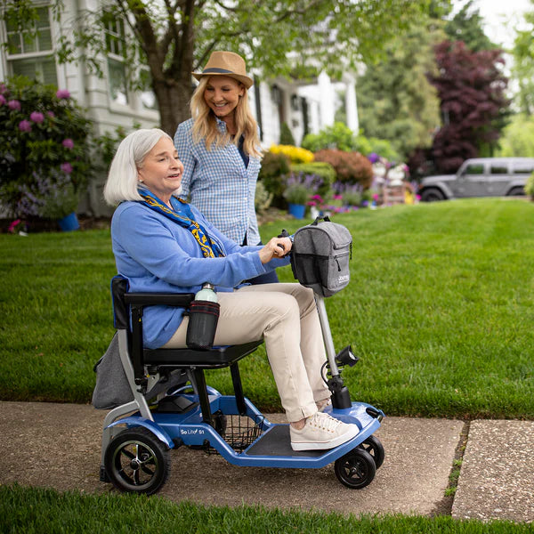 Journey Blue So Lite Folding Power Scooter With Patient In Outdoor View
