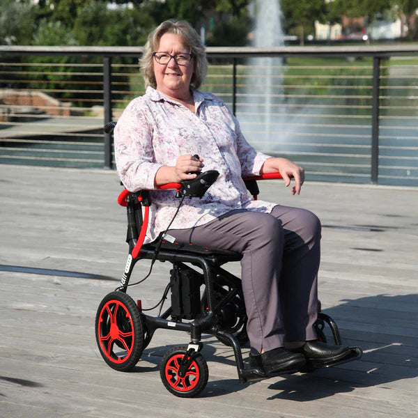 Journey Red Air Elite Lightweight Folding Power Chair With Rider View