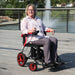Journey Red Air Elite Lightweight Folding Power Chair With Rider View