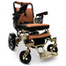 Bronze Frame and Taba Textile ComfyGO MAJESTIC IQ-7000 Auto Folding Electric Wheelchair Lightweight, Airline-Friendly, and Travel Ready with premium quilted taba seat and backrest with gold stitching and joystick controller is mounted on the right armrest