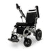 Standard Silver ComfyGO MAJESTIC IQ-8000 Standard Remote Controlled Lightweight Electric Wheelchair with both armrests raised and joystick controller is mounted on the right armrest