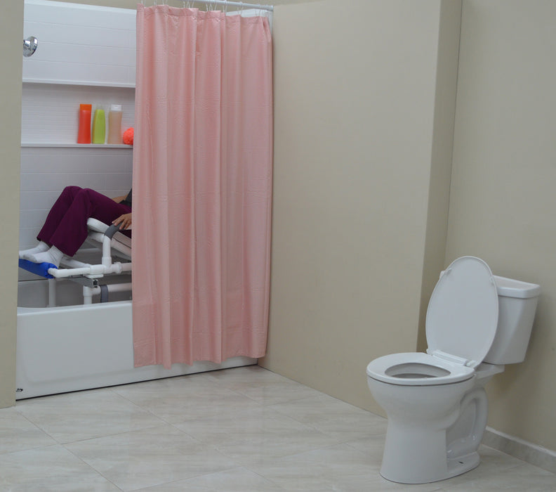 MJM International All Purpose Dual Shower Transfer Chair With Tilt Slider In Bathroom Setting With Patient In Reclined Head And Knee Raised Position Slide In Bathtub No Bridge Privacy