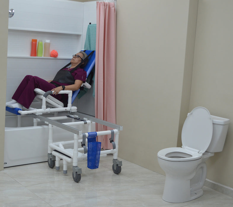 MJM International All Purpose Dual Shower Transfer Chair With Tilt Slider In Bathroom Setting With Patient In Reclined Head And Knee Raised Position Slide In Bathtub View