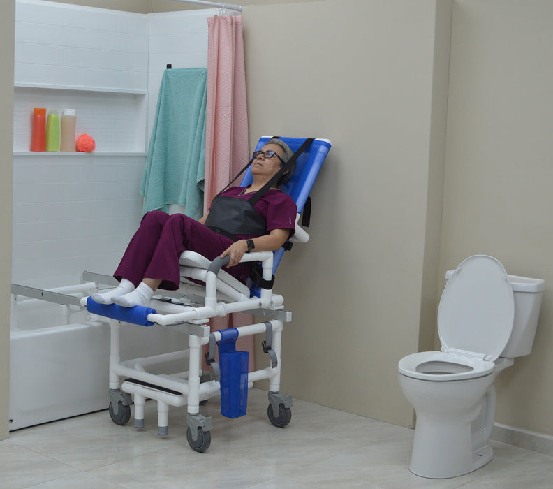 MJM International All Purpose Dual Shower Transfer Chair With Tilt Slider In Bathroom Setting With Patient In Reclined Head And Knee Raised Position View