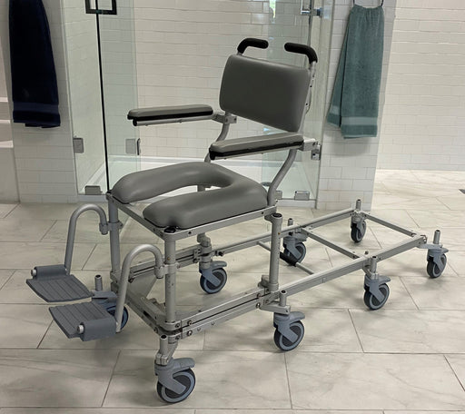Nuprodx MC6000RS Commode Chair With Shower Access Slider System Padded Backrest Flip Up Armrest Cushion Seat Swing Away Footrest With Derlin Caster Wheels And Shower Access Slider System View