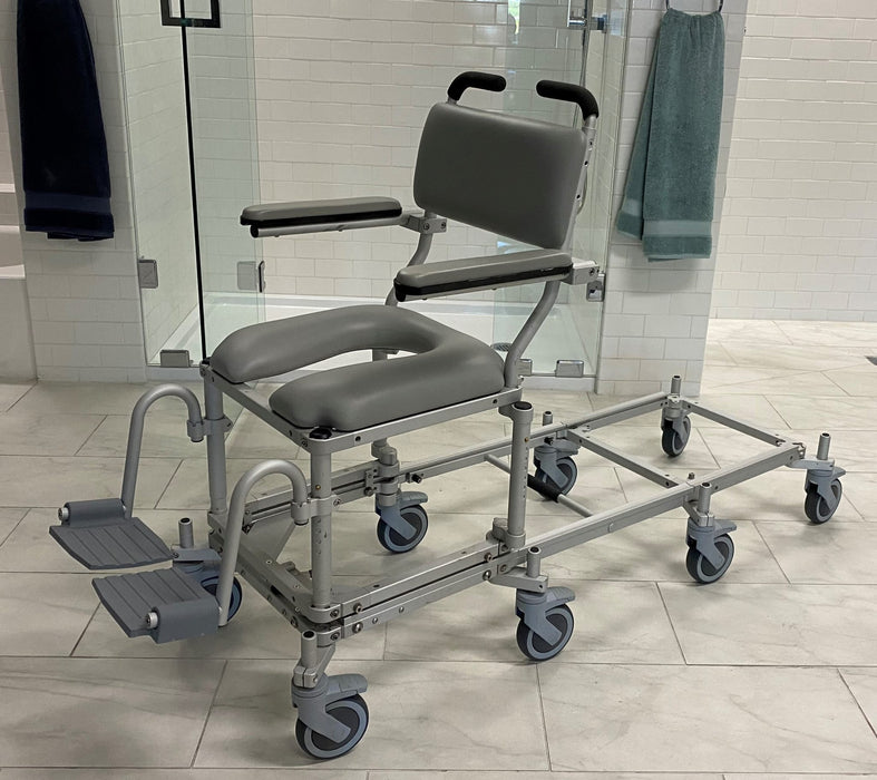 Nuprodx MC6000RS Commode Chair With Shower Access Slider System Padded Backrest Flip Up Armrest Cushion Seat Swing Away Footrest With Derlin Caster Wheels And Shower Access Slider System View