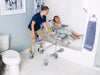 Nuprodx MC6000TiltPed Pediatric Tilt In Space Commode Tub Transfer System With Patient And Caregiver Removing Connector Bridge View