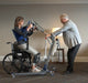 Proactive Medical Protekt® STS Compact 500 Sit to Stand Lift With Patient And Caregiver In Wheelchair Transfer View