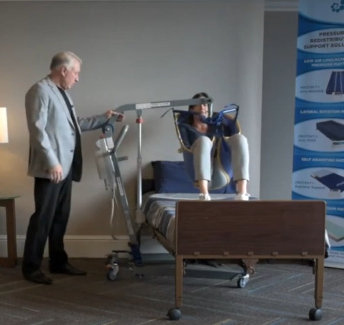 Proactive Medical Protekt® All-In-One Folding Electric Patient Lift With Patient And Caregiver In Bed Transfer View