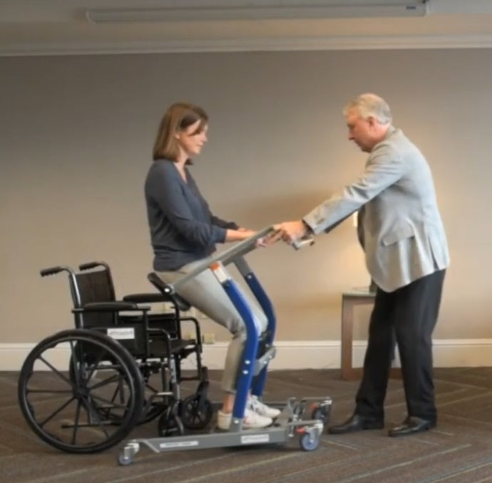 Proactive Medical Protekt® Dash Sit to Stand Lift With Patient And Caregiver In Wheelchair Transfer View