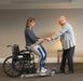 Proactive Medical Protekt® Dash Sit to Stand Lift With Patient And Caregiver In Wheelchair Transfer View