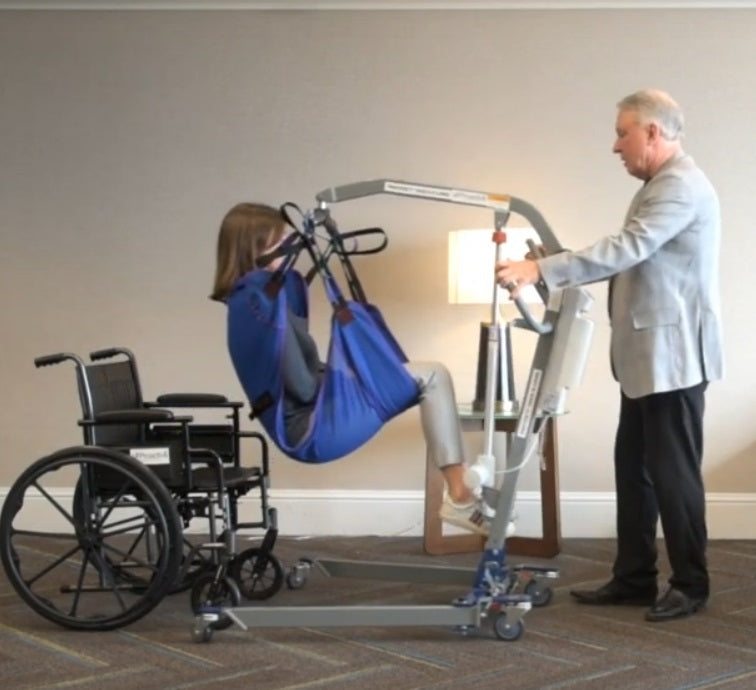 Proactive Medical Protekt® Take-A-Long Folding Electric Patient Lift With Patient And Caregiver In Wheelchair Transfer View