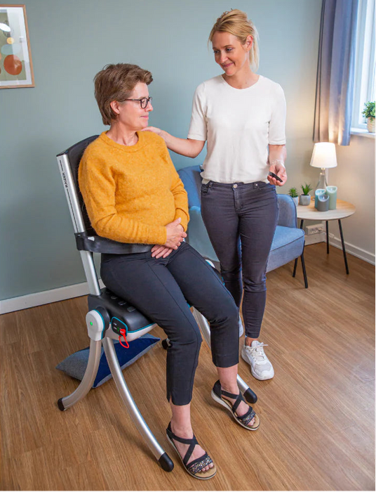 RizeUp Raizer II battery-operated lifting chair with carer assistance and seated user for emergency lift recovery.