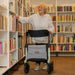 Rollz Air Carbon Rollator In Mint Green Being Navigated By A User Indoors.