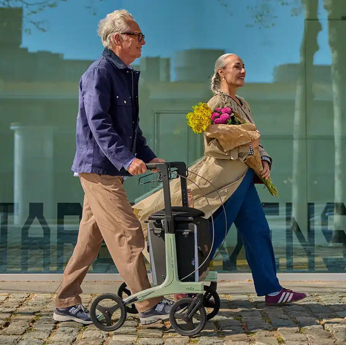 Rollz Air Carbon Rollator In Mint Green Side View Of An Active User Outdoors.