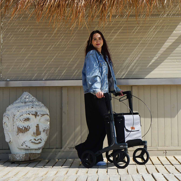 Rollz Air Carbon Rollator In Mint Green Being Guided By A User Outdoors.